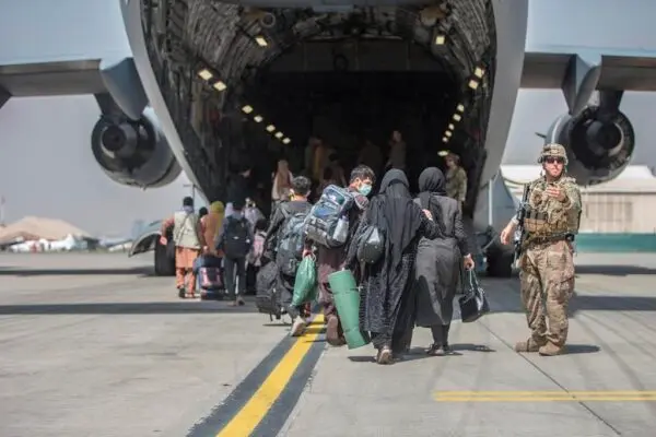 In this photo provided by the U. S. Marine Corps, people begin to table a U. S. Air Force Boeing C- 17 Globemaster III during an departure at Hamid Karzai International Airport in Kabul, Afghanistan, on Aug. 23, 2021. ( Sergeant. Samuel Ruiz/U. S. Marine Corps via AP )