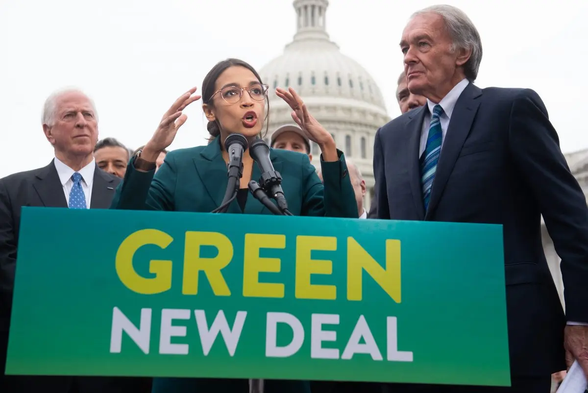 Rep. Alexandria Ocasio- Cortez ( D- N. Y. ) and Sen. Ed Markey ( D- Mass. ) speak at a press conference on February 7, 2019 to announce the Green New Deal's plan to support clean energy initiatives outside the US Capitol in Washington. ( Saul Loeb/AFP/Getty Images )