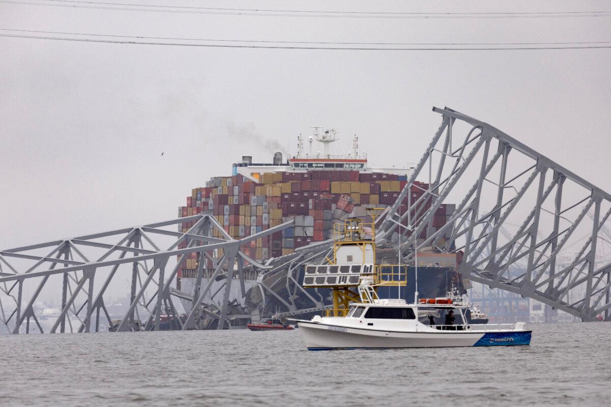 After the cargo ship Dali and the Francis Scott Key Bridge collided, causing it to collapse on March 27, 2024, in Baltimore, workers continue to look for victims. ( Scott Olson/Getty Images )