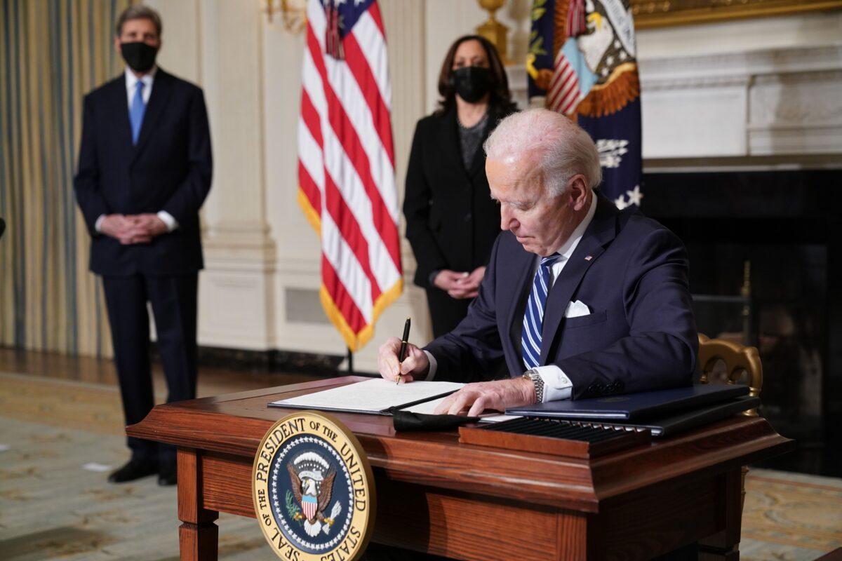 President Joe Biden signs several executive orders relating to climate change, including one that places a pause on new oil and natural gas leases on public land in the State Dining Room of the White House in Washington on January 27, 2021. Vice President Kamala Harris ( 2- L) and special presidential envoy for climate change John Kerry ( L ) watch as President Obama signs several executive orders directing a pause on new oil and natural gas leases on public land. ( Mandel Ngan/AFP via Getty Images )