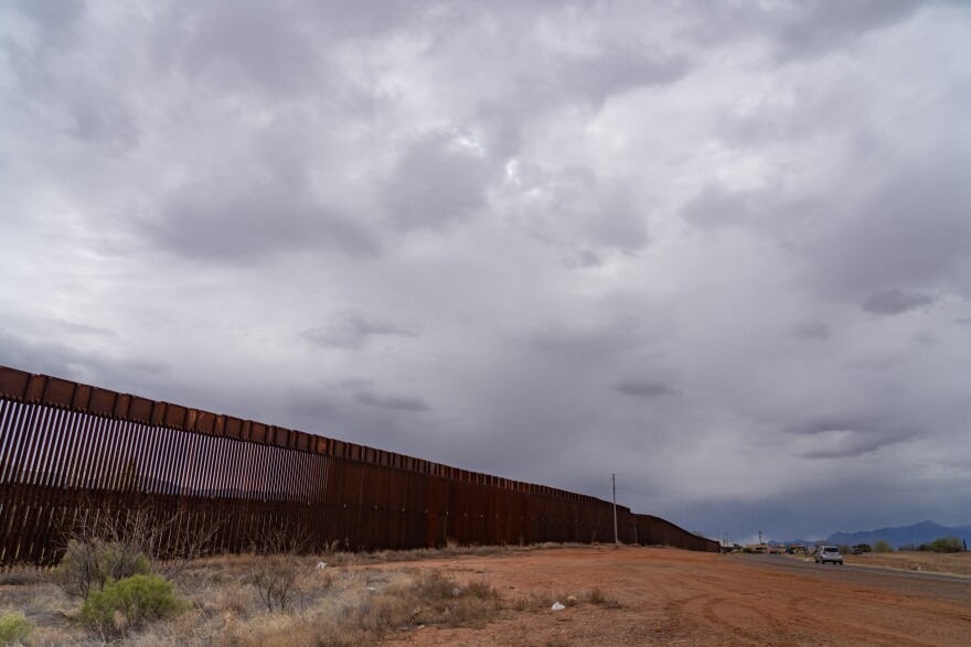 The border wall extends from downtown Naco, Ariz. to as far as the eye can see.