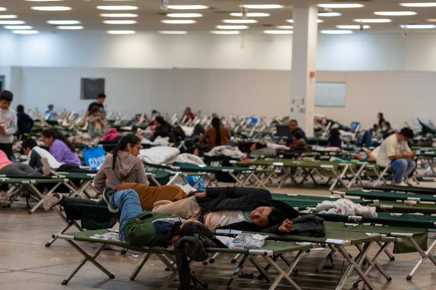 Asylum seekers are squatting on beds in Casa Alitas, a momentary housing facility.