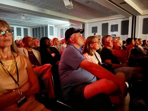 Audience members watch the premiere of the documentary 