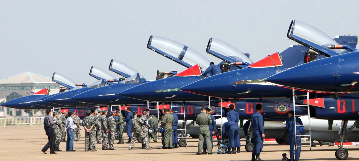 Pilots check a group of seven Chinese-made Jian-10 fighter jets, which will perform aerial stunts at the Air Show in Zhuhai, south China's Guangdong province, on Nov. 8, 2010. (STR/AFP via Getty Images )